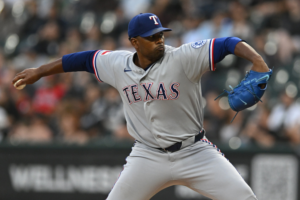 Texas Rangers starter Kumar Rocker delivers a pitch during the first inning of a baseball game against the Chicago White Sox in Chicago, Monday, Aug. 24, 2026. (AP Photo/Paul Beaty)