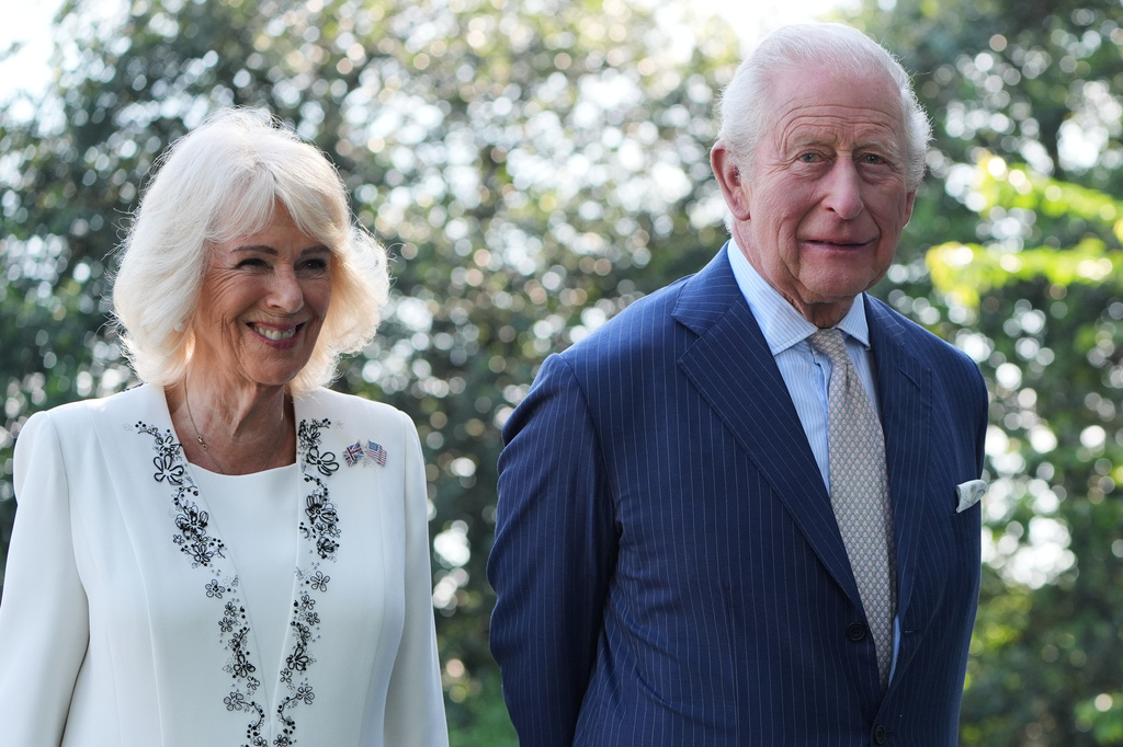Britain's King Charles III and Queen Camilla stand next to the White House bee hive on the South Lawn of the White House, Monday, April 27, 2026, in Washington. (AP Photo/Alex Brandon, Pool)