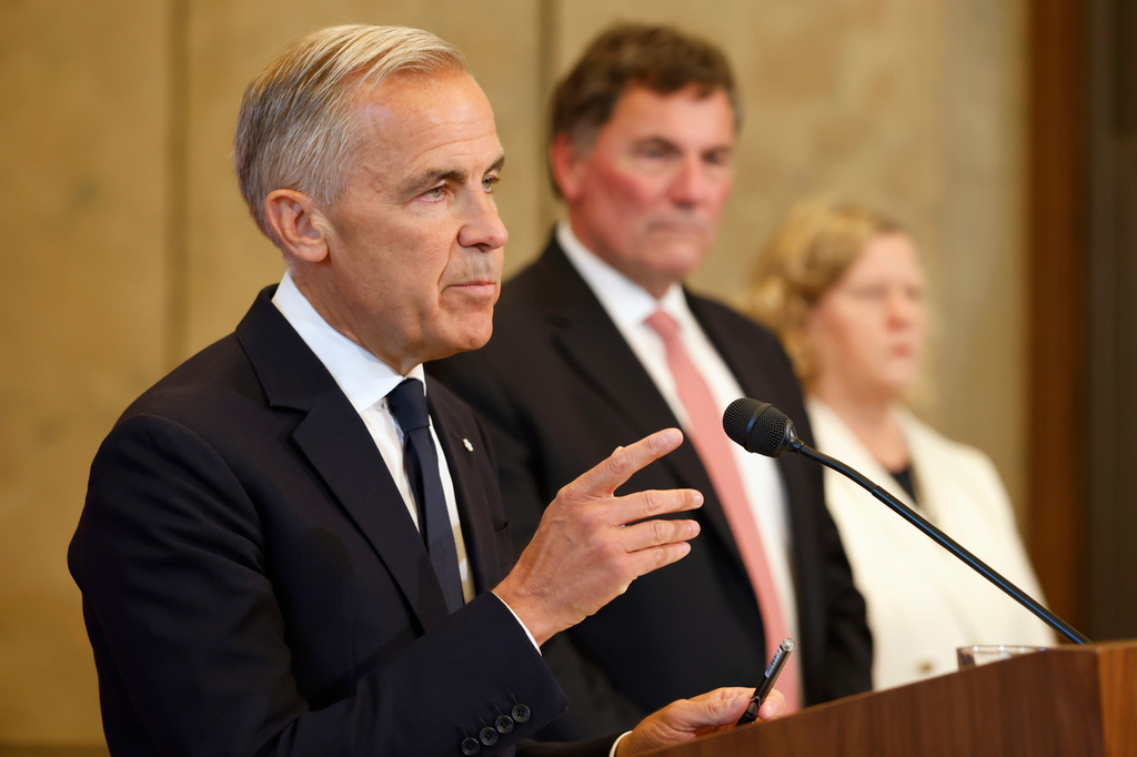 Canada-U.S. Trade Minister Dominic LeBlanc and chief trade negotiator Janice Charette listen as Prime Minister Mark Carney speaks about Canada's response to new U.S. tariffs during a news conference on Parliament Hill in Ottawa on Saturday, Aug. 22, 2026. (Patrick Doyle/The Canadian Press via AP)