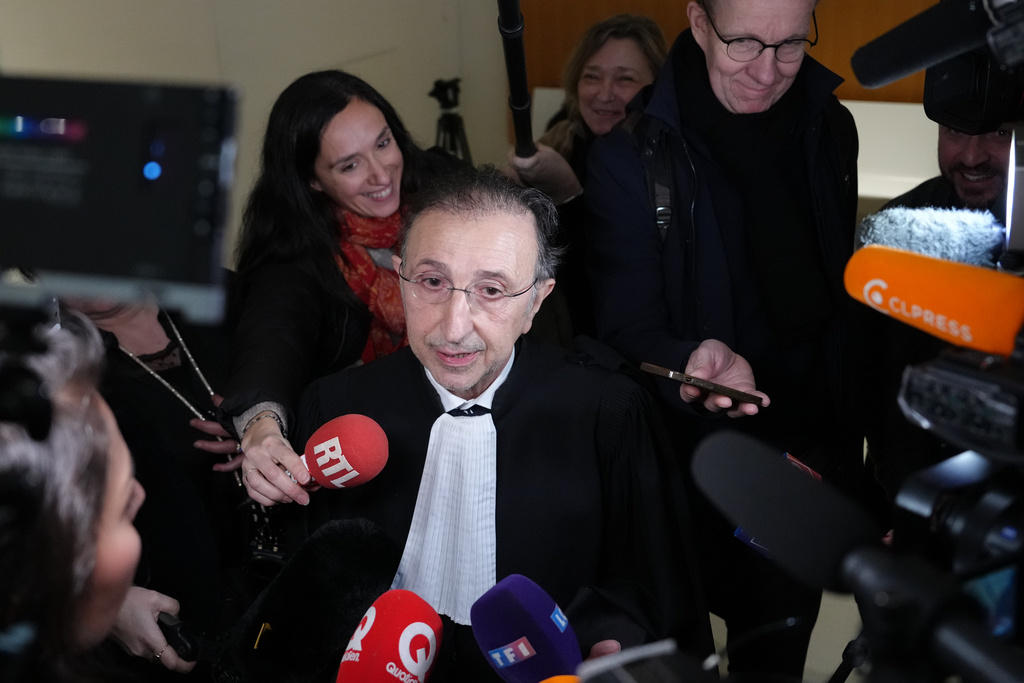 Brigitte Macron's lawyer Jean Ennochi answers reporters after a Paris court has found 10 people guilty of cyberbullying France's first lady, Brigitte Macron by spreading false online claims about her gender and sexuality, Monday, Jan. 5, 2026 in Paris. (AP Photo/Aurelien Morissard)