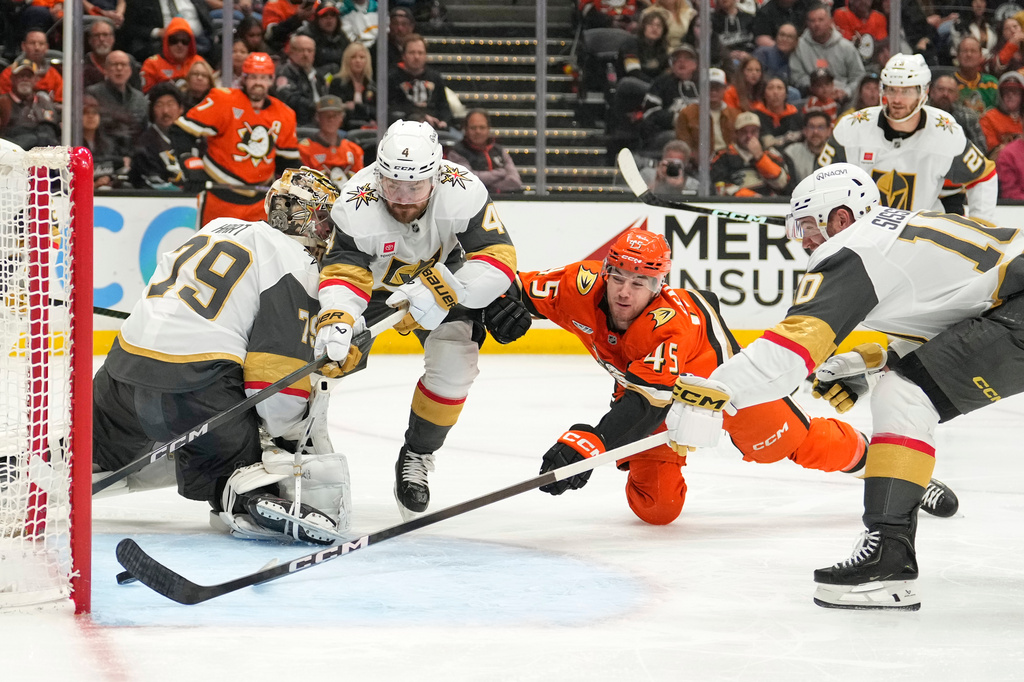 Anaheim Ducks right wing Beckett Sennecke, second from right, scores as Vegas Golden Knights goaltender Carter Hart, left, watches and defenseman Rasmus Andersson, second from left, and center Colton Sissons try to defend during the third period in Game 3 of a second-round NHL hockey Stanley Cup playoff series Friday, May 8, 2026, in Anaheim, Calif. (AP Photo/Mark J. Terrill)