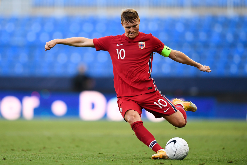 FILE - Norway's Martin Odegaard takes a shot during the international friendly soccer match between Norway and Greece at the La Rosaleda stadium in Malaga, Spain, Sunday, June 6, 2021. (AP Photo/Jose Breton, File)