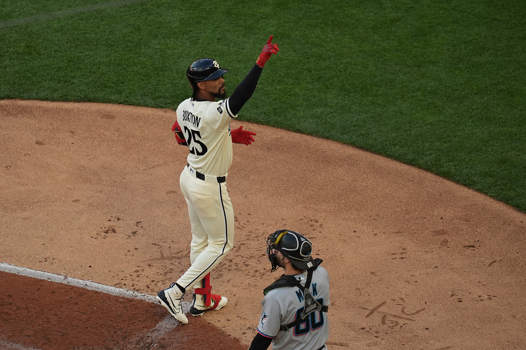 Minnesota Twins' Byron Buxton (25) points after crossing home plate after hitting a solo home run during the first inning of a baseball game against the Miami Marlins Wednesday, May 13, 2026, in Minneapolis. (AP Photo/Abbie Parr)