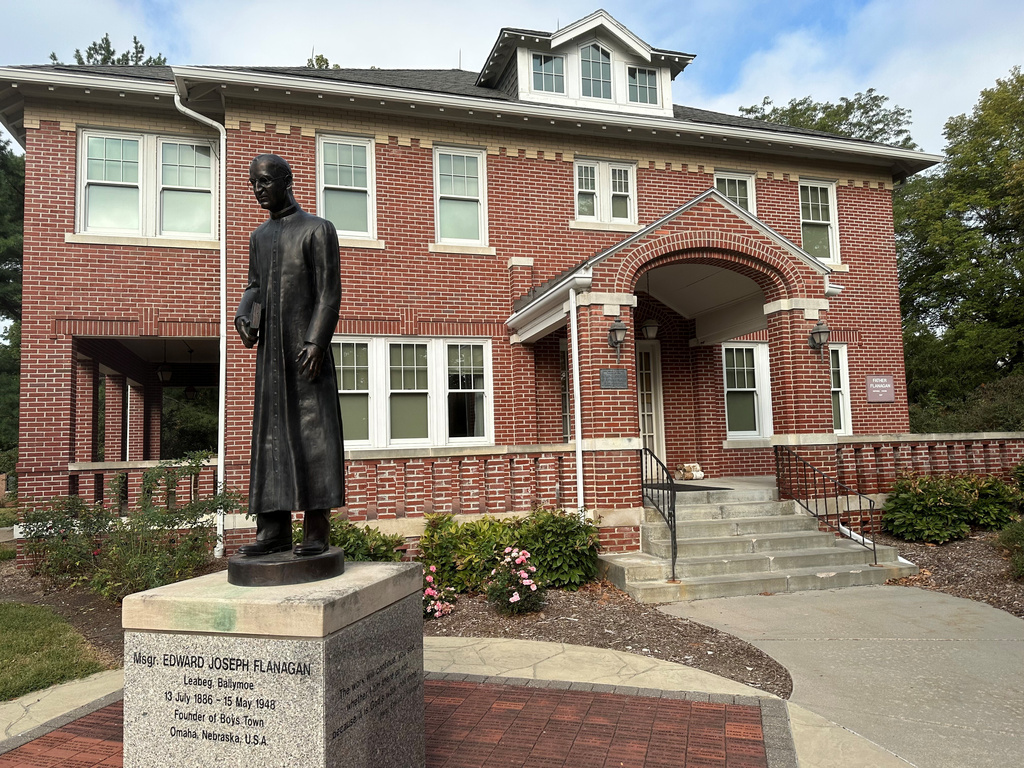 A statue of the Rev. Edward Flanagan is seen outside the home where he lived in Boys Town, Neb., on Sept. 14, 2024. (AP Photo/Peter Smith)