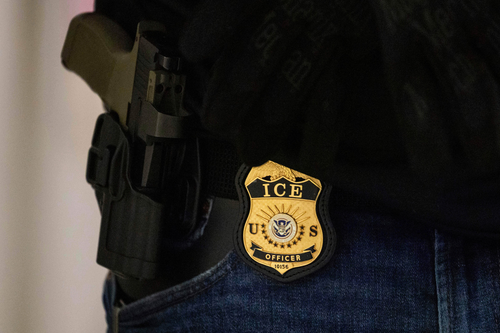 FILE - A federal agent wears a badge of Immigration and Customs Enforcement at the immigration court at Jacob K. Javits Federal Building in New York, on June 9, 2025. (AP Photo/Yuki Iwamura, File)