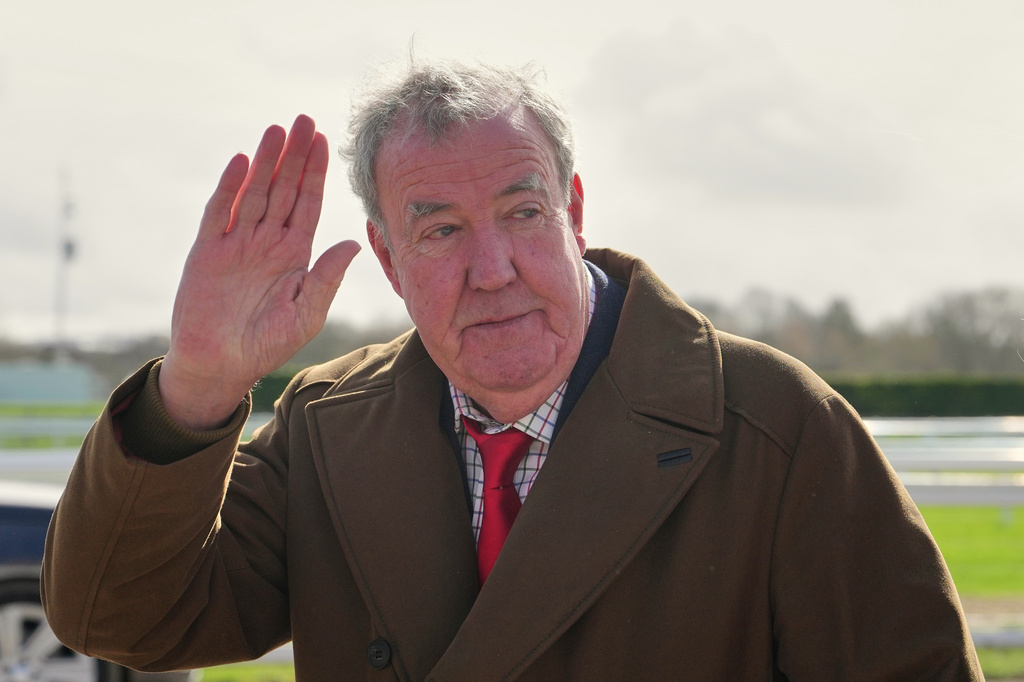 FILE - TV presenter Jeremy Clarkson waves to the media as he arrives on day four of the 2026 Cheltenham Festival in Cheltenham, England, on March 13, 2026. (AP Photo/Dave Shopland, File)