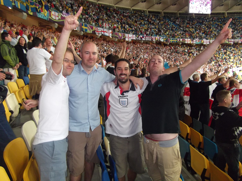 In this image provided by Stuart Thorpe, Mike Wilson, second-from-right, and his friends pose at a Euro 2012 soccer championship Group D match between Sweden and England in Kiev, Ukraine, Friday, June 15, 2012. (Stuart Thorpe via AP)