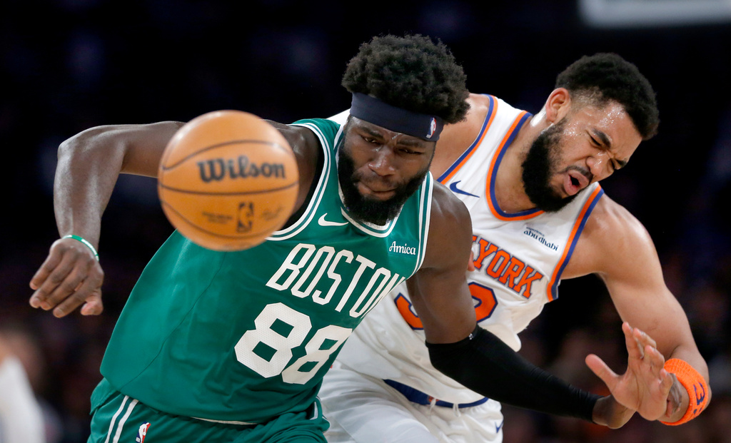 Boston Celtics center Neemias Queta, left, and New York Knicks center Karl-Anthony Towns battle for a loose ball during the first half of an NBA basketball game Thursday, April 9, 2026, in New York. (AP Photo/John Munson)