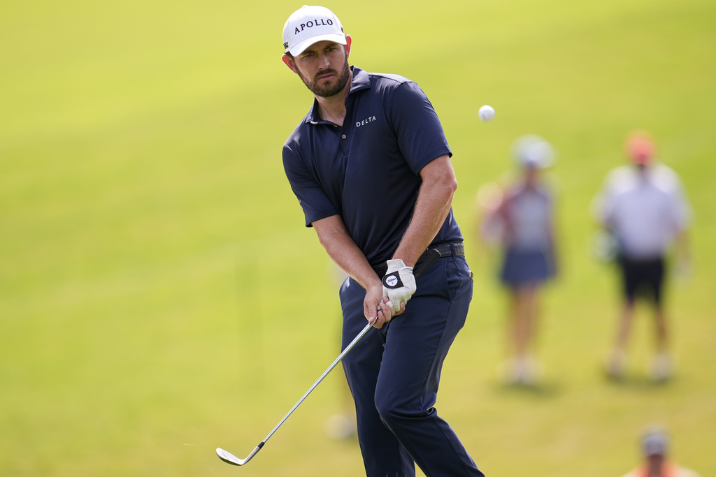 Patrick Cantlay chips to the 11th green during the final round of the Tour Championship golf tournament, Sunday, Aug. 24, 2025, in Atlanta. (AP Photo/Mike Stewart)