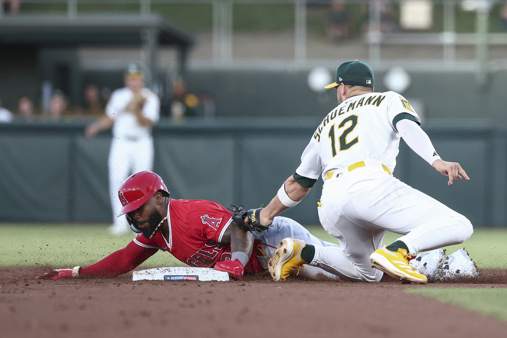 Athletics third baseman Max Schuemann, right, attempts to tag out Los Angeles Angels' Luis Rengifo as he steals second base during the second inning of a baseball game Saturday, Aug. 16, 2025, in West Sacramento, Calif. (AP Photo/Sara Nevis)