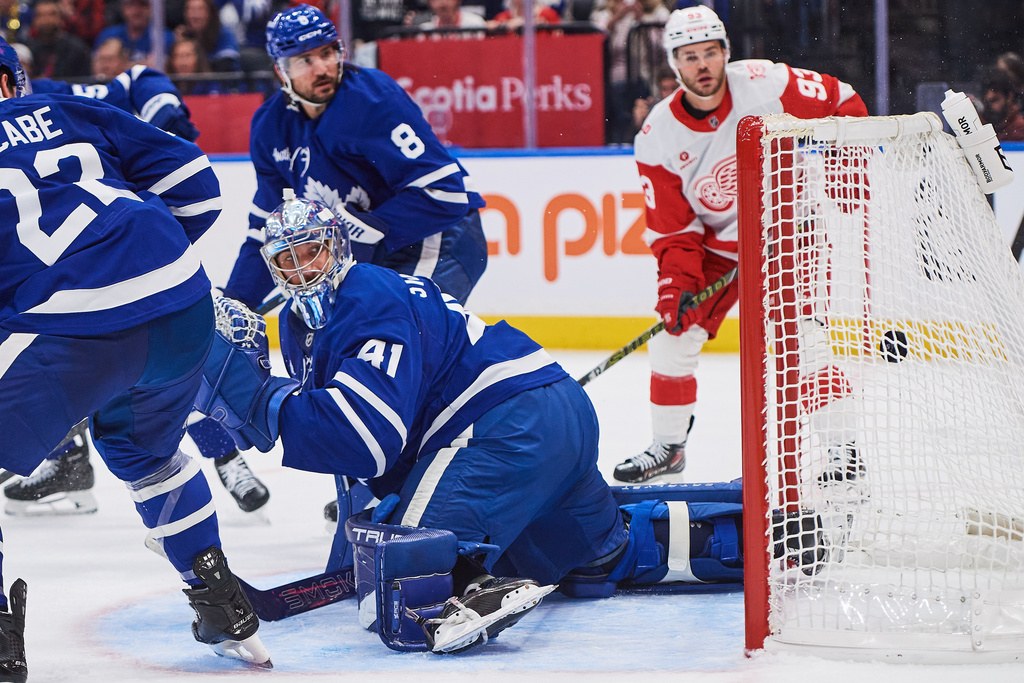 Toronto Maple Leafs goaltender Anthony Stolarz (41) can't make the save as Detroit Red Wings' Dylan Larkin (71) scores during first period NHL hockey action in Toronto, Monday, Oct. 13, 2025. (Sammy Kogan/The Canadian Press via AP)
