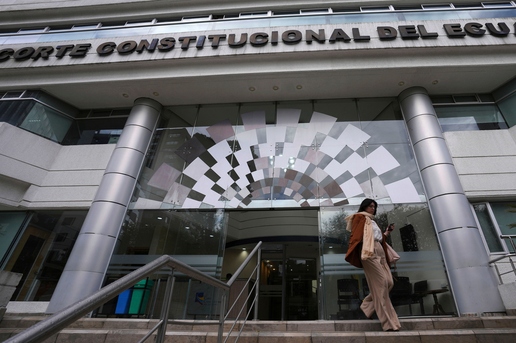 FILE - A woman exits the Constitutional Court building, in Quito, Ecuador, Feb. 7, 2024. (AP Photo/Dolores Ochoa, File)
