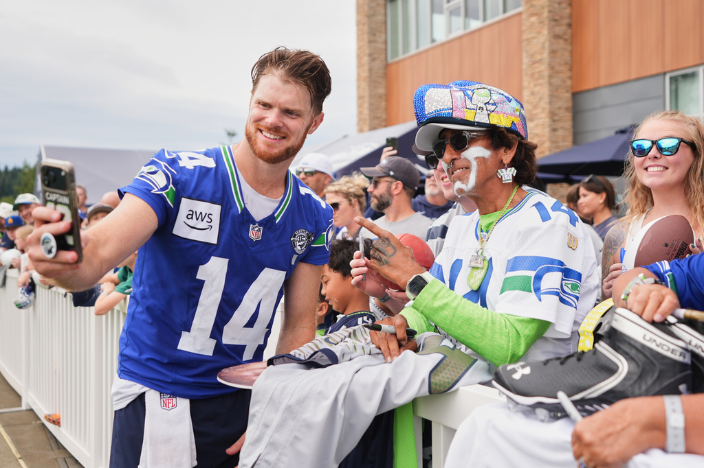 Seattle Seahawks quarterback Sam Darnold takes a selfie during the NFL football team's training camp, Sunday, July 26, 2026, in Renton, Wash. (AP Photo/Lindsey Wasson)