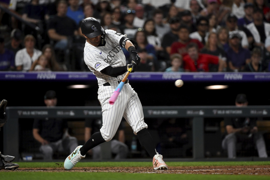 Colorado Rockies' Tyler Freeman (2) hits a two-run home run in the eighth inning of a baseball game against the Arizona Diamondbacks Saturday, Aug. 16, 2025, in Denver. (AP Photo/Geneva Heffernan)