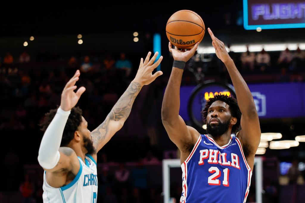 Philadelphia 76ers center Joel Embiid (21) shoots against Charlotte Hornets forward Miles Bridges during the second half of an NBA basketball game in Charlotte, N.C., Saturday, March 28, 2026. (AP Photo/Nell Redmond)