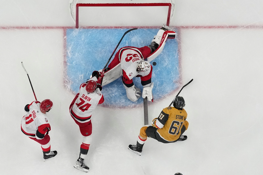 Carolina Hurricanes goaltender Brandon Bussi (32) blocks a shot by by Vegas Golden Knights right wing Mark Stone (61) during Game 6 of the NHL hockey Stanley Cup Final series , Sunday, June 14, 2026, in Las Vegas. (AP Photo/John Locher)
