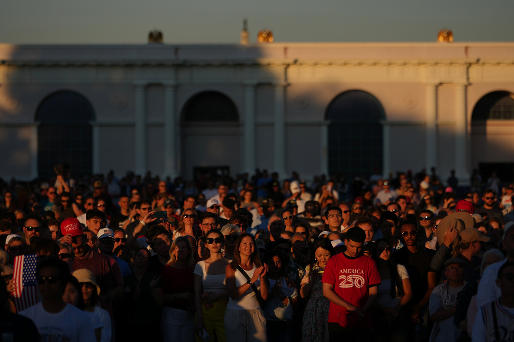 People listen to speakers before President Donald Trump arrives at the opening of the Great American State Fair on the National Mall, Wednesday, June 24, 2026, in Washington. (AP Photo/Julia Demaree Nikhinson)
