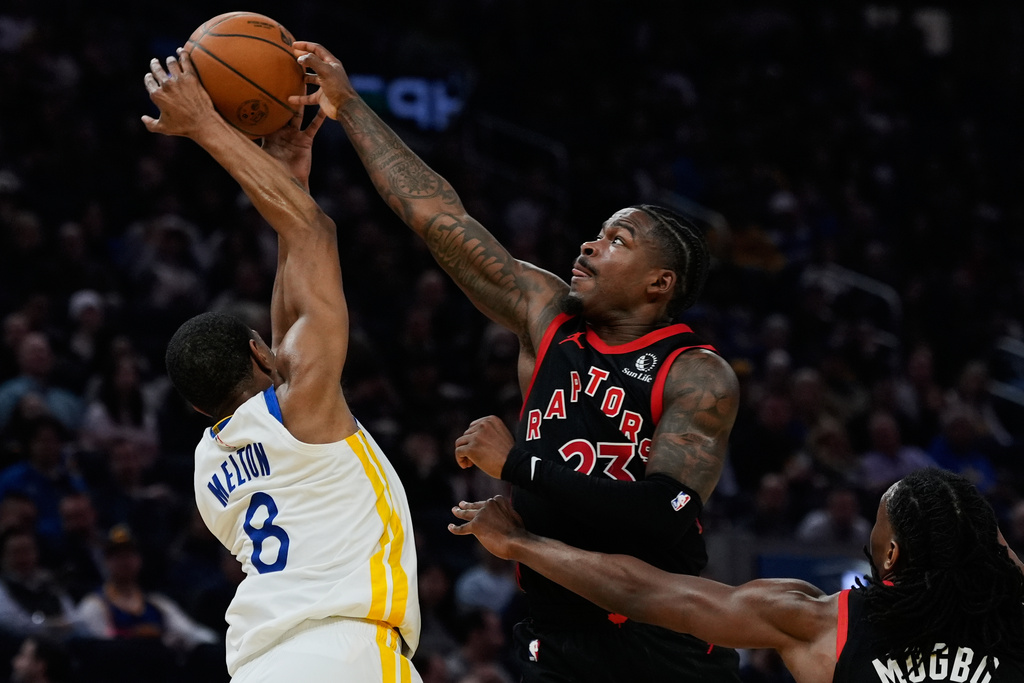 Golden State Warriors guard De'Anthony Melton (8) and Toronto Raptors guard Jamal Shead (23) compete for possession of the ball during the first half of an NBA basketball game, Tuesday, Jan. 20, 2026, in San Francisco. (AP Photo/Godofredo A. Vásquez)