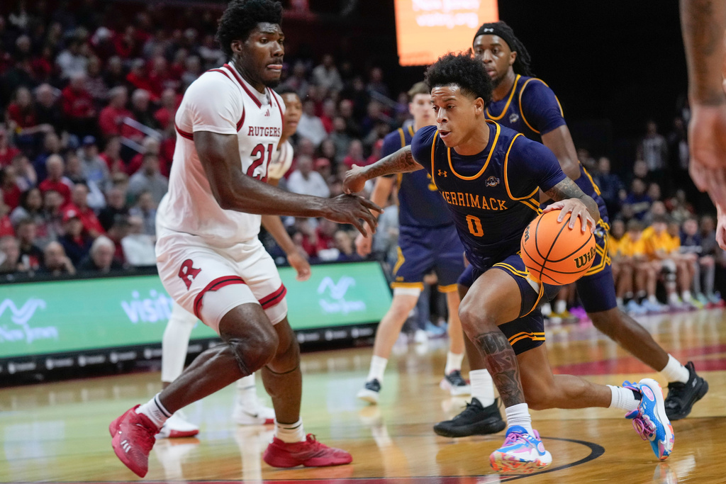 FILE - Merrimack's Adam Clark (0), right, who has since transferred to Seton Hall, drives to the basket during the first half of an NCAA college basketball game against Rutgers Wednesday, Nov. 20, 2024, in Piscataway, N.J. (AP Photo/Seth Wenig, File)