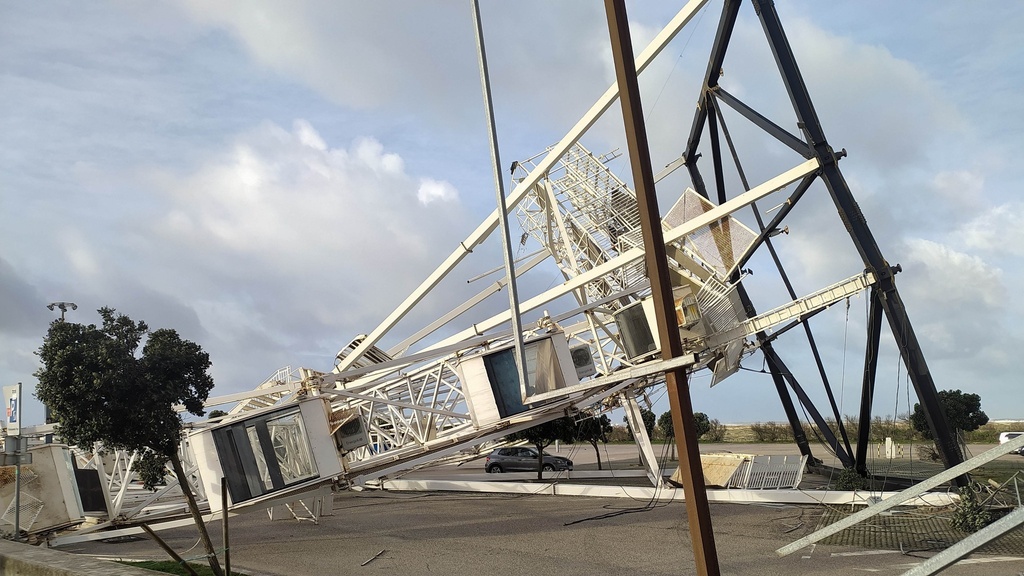 A ferris wheel is seen collapsed on the ground after it toppled during the passage of storm Kristin in Figueira da Foz, Portugal, Wednesday, Jan. 28, 2026. (Figueira Na Hora/Jorge Lemos via AP)