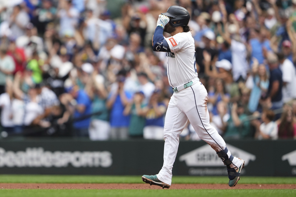Seattle Mariners' Eugenio Suarez celebrates while running the bases after hitting a three-run home run during the fourth inning of a baseball game against the San Diego Padres, Wednesday, Aug. 27, 2025, in Seattle. (AP Photo/Lindsey Wasson)