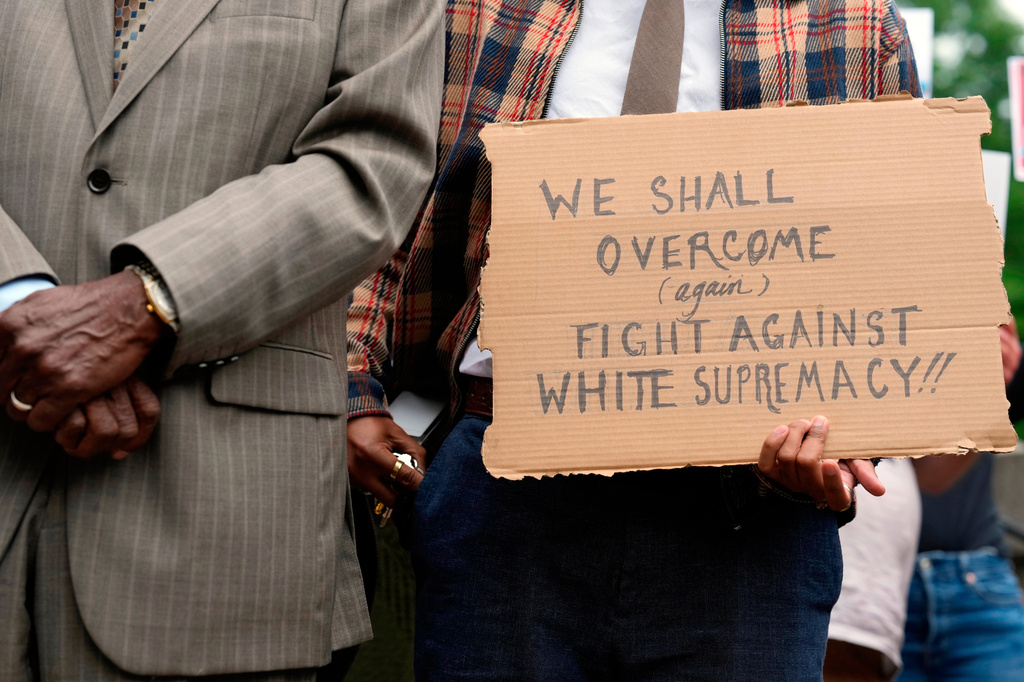 A person holds a sign during news conference before a special session of the state legislature to redraw U.S. Congressional voting maps Tuesday, May 5, 2026, in Nashville, Tenn. (AP Photo/George Walker IV)