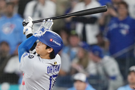 Los Angeles Dodgers' Shohei Ohtani (17) hits a two-run home run against the Toronto Blue Jays during the sixth inning in Game 1 of baseball's World Series, Friday, Oct. 24, 2025, in Toronto. (Nathan Denette/The Canadian Press via AP) Los Angeles Dodgers' Shohei Ohtani (17) hits a two-run home run against the Toronto Blue Jays during the sixth inning in Game 1 of baseball's World Series, Friday, Oct. 24, 2025, in Toronto. (Nathan Denette/The Canadian Press via AP)