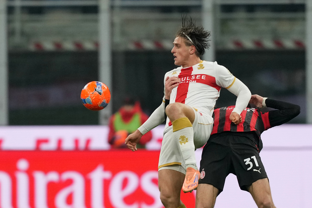 Genoa's Lorenzo Colombo, left, and AC Milan's Strahinja Pavlovic challenge for the ball during the Serie A soccer match between AC Milan and Genoa, in Milan, Italy, Thursday, Jan. 8, 2026. (AP Photo/Antonio Calanni)