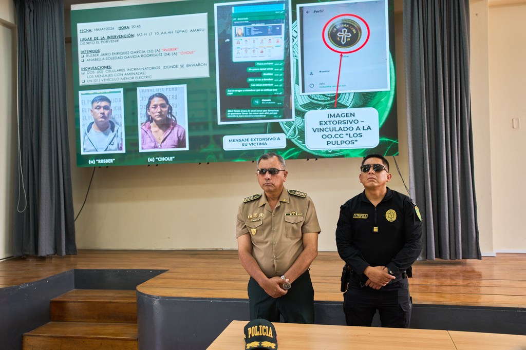 Police officers display evidence during a news conference following the arrest of alleged members of a criminal gang in Trujillo, Peru, Tuesday, May 19, 2026. (AP Photo/Rodrigo Abd)
