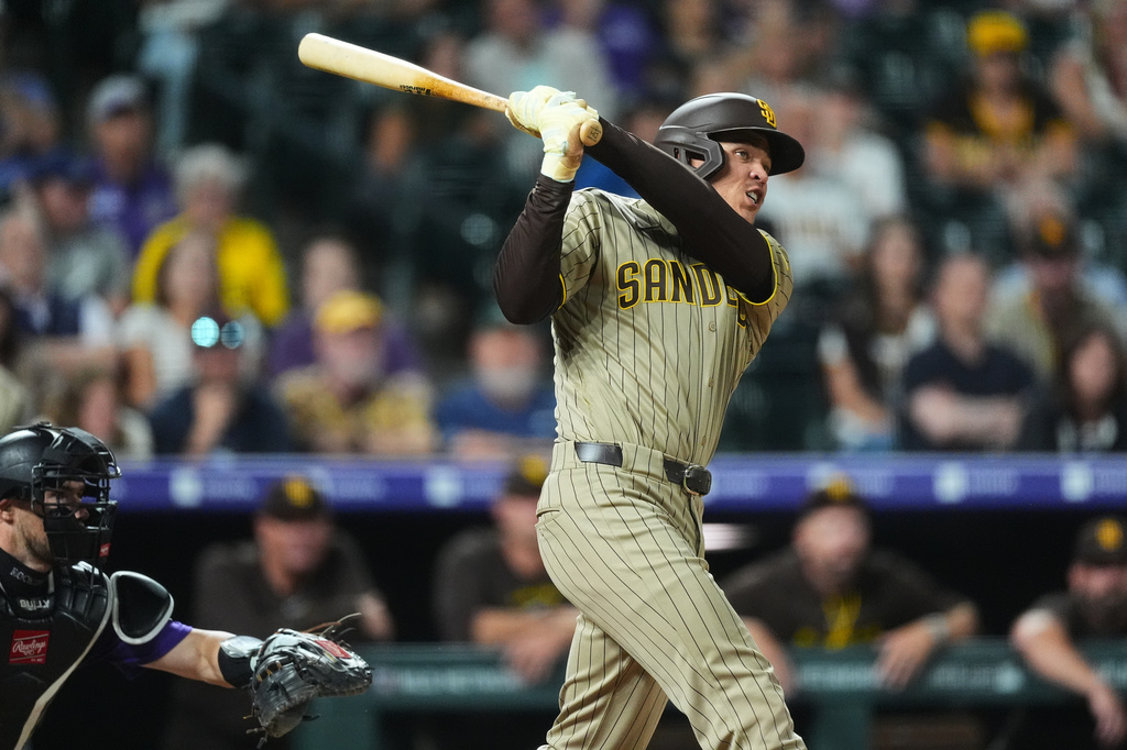 San Diego Padres' Dustin Harris connects for an RBI double off Colorado Rockies relief pitcher Juan Mejia in the eighth inning of a baseball game Monday, Sept. 14, 2026, in Denver. (AP Photo/David Zalubowski)