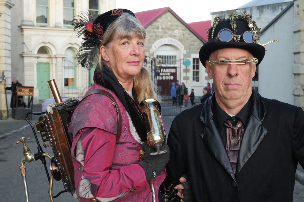 Steampunk NZ Festival attendees Juliet Thorn and Greg Thorn, dressed as their steampunk personas Lady Sarsaparilla Ovabyte and Captain Bob McSpoon, pose for a portrait during the annual event in Ōamaru, New Zealand, on May 29, 2026. (AP Photo/Charlotte Graham-McLay)