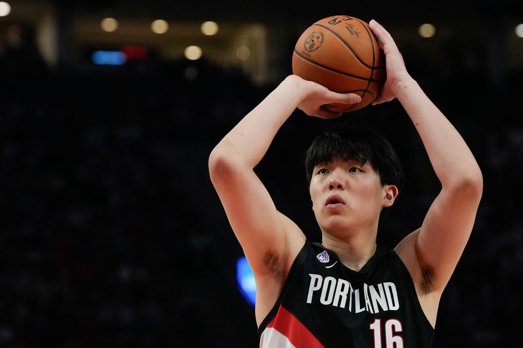 Portland Trail Blazers center Yang Hansen shoots during the first half of NBA basketball game against the Minnesota Timberwolves on Wednesday, Oct. 22, 2025, in Portland, Ore. It was his first point scored during a regular season NBA basketball game. (AP Photo/Jenny Kane)