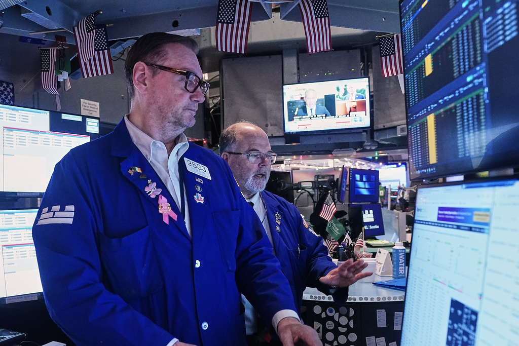 Specialists Patrick King, left, and Douglas Johnson work on the floor of the New York Stock Exchange, Friday, Jan. 2, 2026. (AP Photo/Richard Drew)