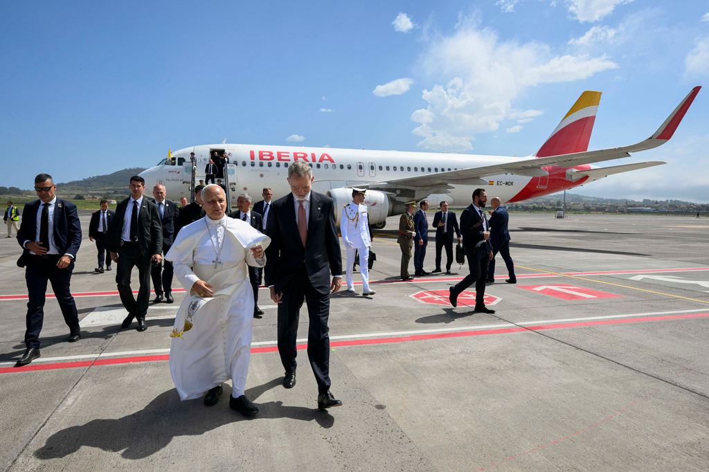 In this handout photo provided by Vatican Media, Pope Leo XIV is accompanied by King Felipe VI of Spain as he deplanes after a technical problem at Tenerife Norte-Los Rodeos International Airport in Tenerife, Spain, Friday, June 12, 2026. (Vatican Media via AP)
