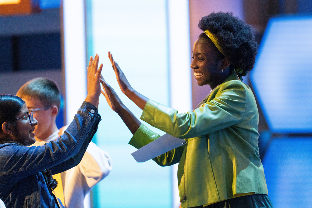 Keona-Dannette Osae-Twum, 13, of Waldwick, N.J., celebrates after making it to the semifinal round of the Scripps National Spelling Bee, Wednesday, May 27, 2026, in Washington. (AP Photo/Allison Robbert)