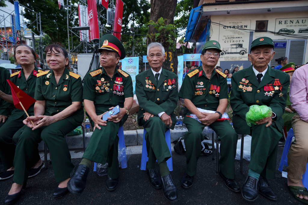 Vietnamese retired veterans wait for military parade rehearsal for the Vietnam's 80th National Day celebration in old town of Hanoi, Vietnam, Saturday, Aug. 30, 2025. (AP Photo/Vincent Thian)