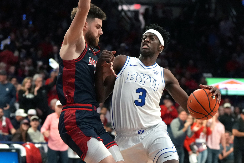 BYU forward AJ Dybantsa (3) drives on Arizona guard Anthony Dell'orso during the first half of an NCAA college basketball game, Wednesday, Feb. 18, 2026, in Tucson, Ariz. (AP Photo/Rick Scuteri)