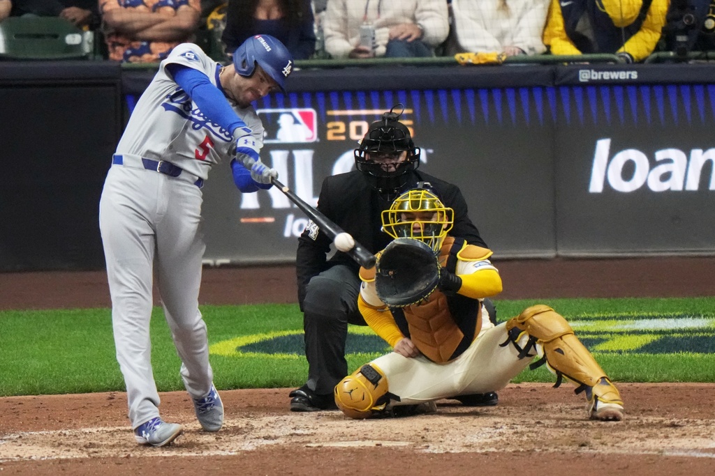 Los Angeles Dodgers' Freddie Freeman hits a double during the eighth inning of Game 1 of baseball's National League Championship Series against the Milwaukee Brewers Monday, Oct. 13, 2025, in Milwaukee. (AP Photo/Morry Gash)