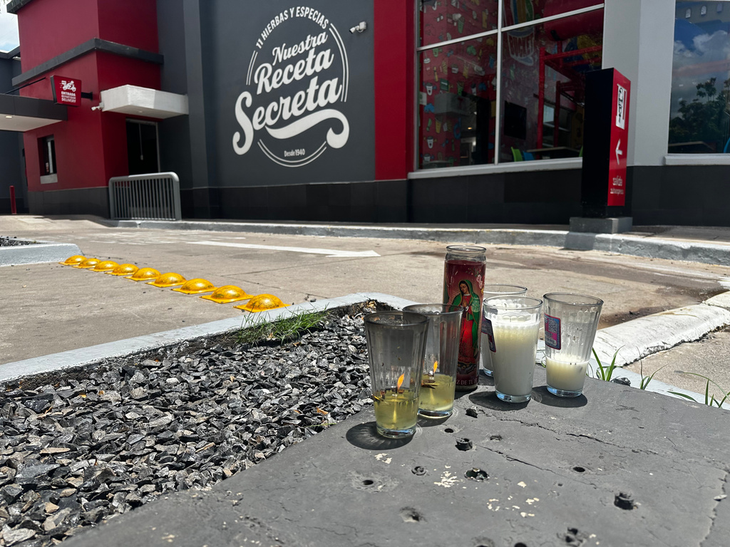 Candles sit near the spot where César Gastélum, a social media influencer, was killed the previous night in Culiacán, Mexico, Wednesday, Aug. 5, 2026. (AP Photo/Aaron Ibarra)