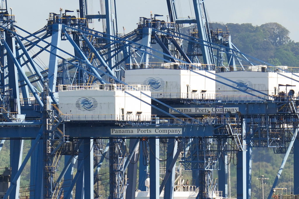 Cranes load a cargo ship at Panama Canal's Port of Balboa, managed by CK Hutchison Holdings, in Panama City, Friday, Jan. 30, 2026. (AP Photo/Matias Delacroix)