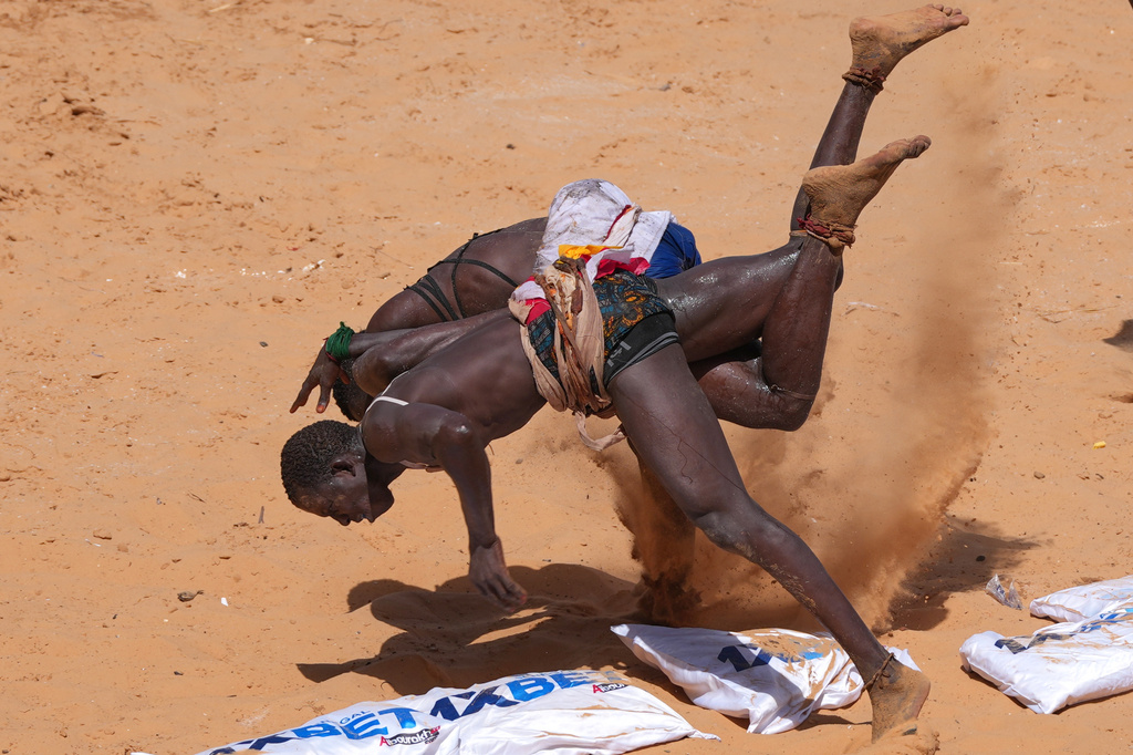 Wrestlers compete at the national wrestling arena in Dakar, Senegal, Sunday, April 5, 2026. (AP Photo/Misper Apawu)