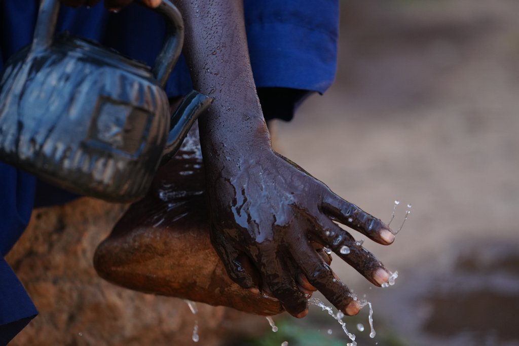 Haruna Adamu, an imam who said he has lost two brothers in the violence, performs ablutions outside a mosque in Kaduna, northwestern Nigeria, Nov. 5, 2025. (AP Photo/Sunday Alamba)