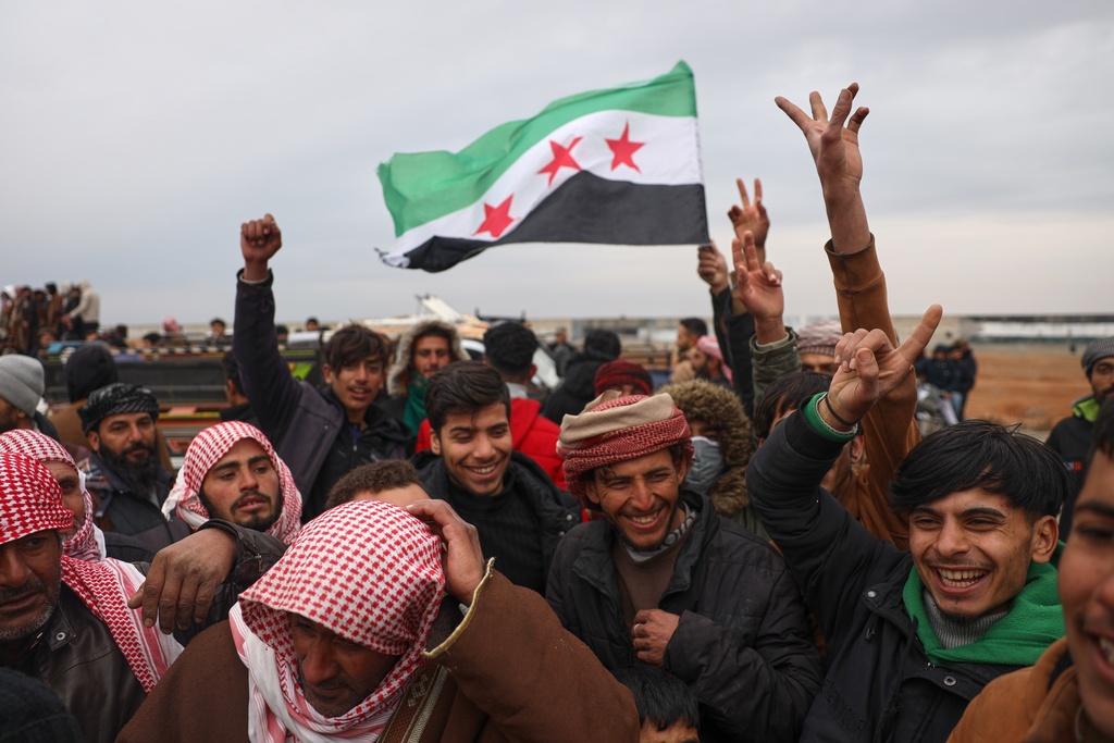 People celebrate as Syrian government forces enter the town of Maskana, Saturday, Jan. 17, 2026, following the withdrawal of the U.S.-backed Syrian Democratic Forces. (AP Photo/Omar Albam)