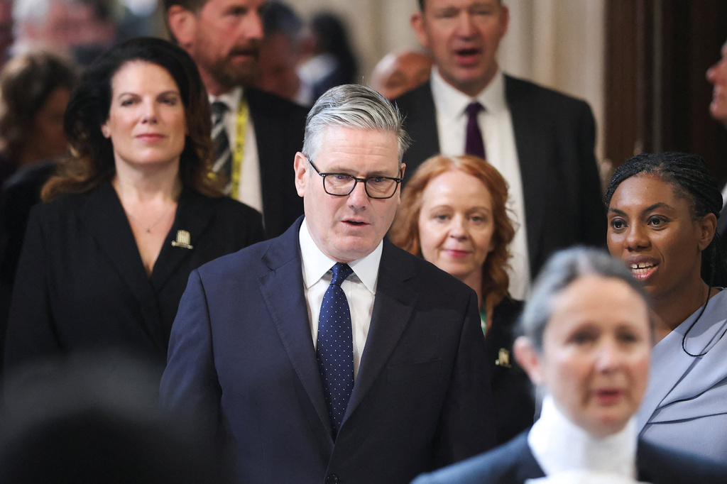 British Prime Minister Keir Starmer, center, walks through the House of Commons to attend the State Opening of Parliament at the Palace of Westminster, London, Wednesday, May 13, 2026. (Toby Melville/Pool Photo via AP)
