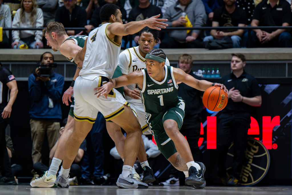 Michigan State guard Jeremy Fears Jr. (1) drives around the defense of Purdue forward Trey Kaufman-Renn (4) during the second half of an NCAA college basketball game, Thursday, Feb. 26, 2026, in West Lafayette, Ind. (AP Photo/Doug McSchooler)