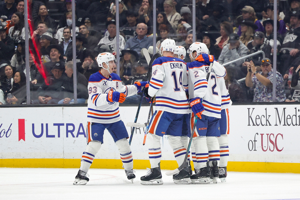 Edmonton Oilers center Connor McDavid, right, celebrates with teammates after scoring during the second period of an NHL hockey game against the Los Angeles Kings Thursday, Feb. 26, 2026 in Los Angeles. (AP Photo/Ryan Sun)