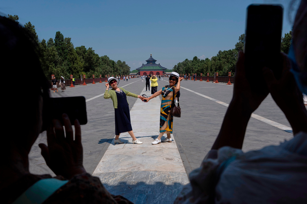 Visitors pose for photos near the Temple of Heaven in Beijing, Monday, May 11, 2026. (AP Photo/Ng Han Guan)