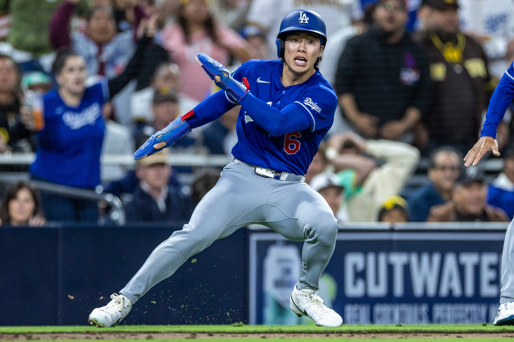 Los Angeles Dodgers' Hyeseong Kim reaches third base safely on a San Diego Padres throwing error in the sixth inning of a baseball game, Monday, May 18, 2026, in San Diego. (AP Photo/Tony Ding)