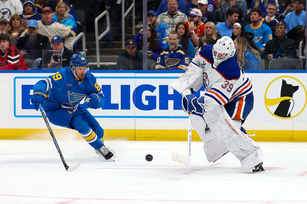 Edmonton Oilers goaltender Connor Ingram (39) clears the puck in front of St. Louis Blues' Pavel Buchnevich (89) during the second period of an NHL hockey game Friday, March 13, 2026, in St. Louis. (AP Photo/Scott Kane)