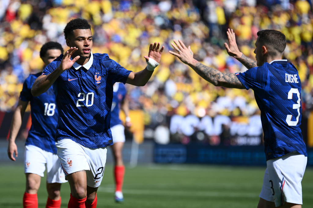 France forward Désiré Doué (20) celebrates with Lucas Digne (3) after scoring the opening goal during the international friendly soccer match between Colombia and France in Landover, Md., Sunday, March 29, 2026. (AP Photo/Nick Wass)